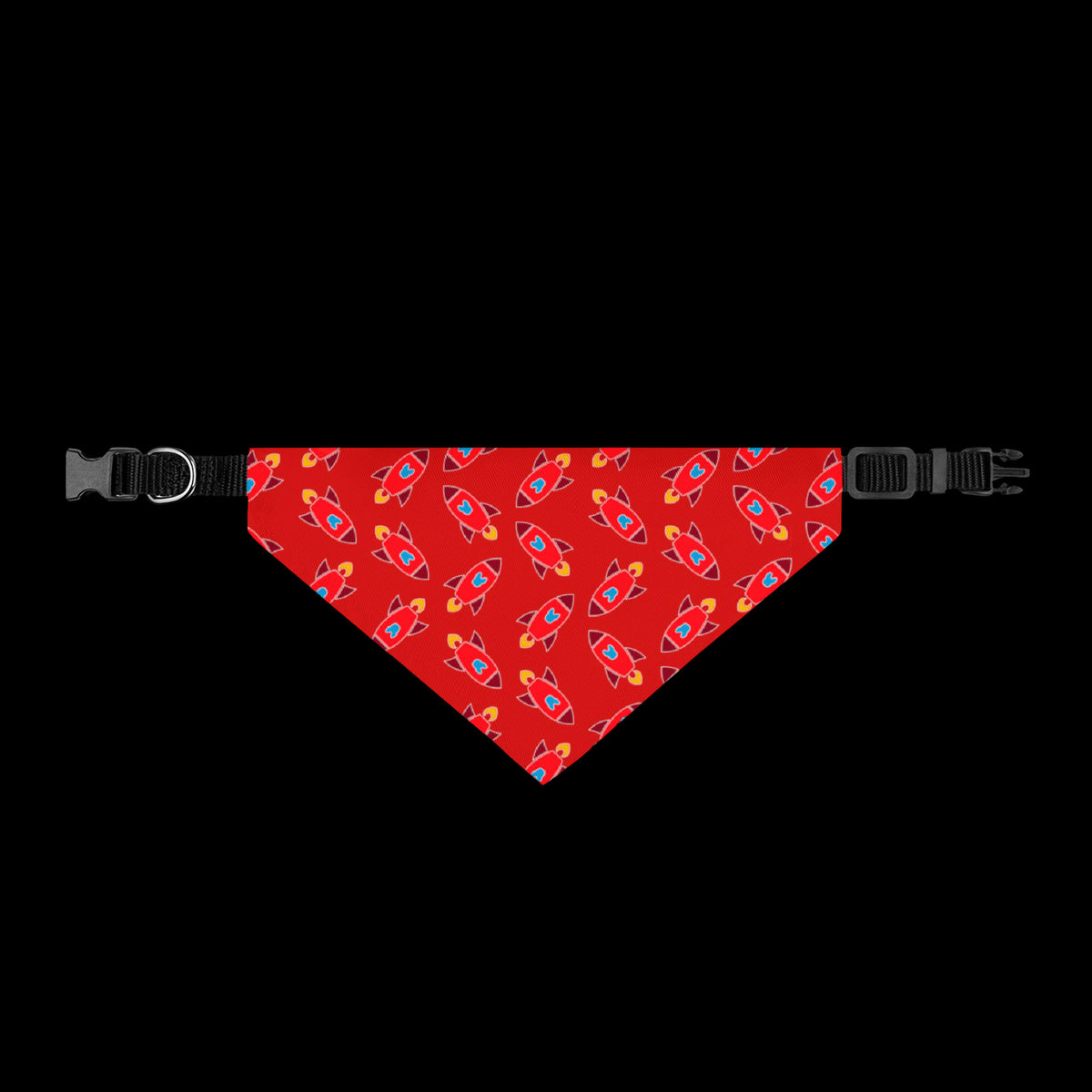 A red pet bandana with a repeating pattern of colorful rockets, shown flat with black plastic buckles on both ends.