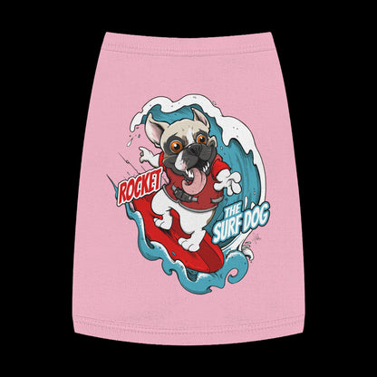 A pink pet shirt featuring a colorful graphic of a French Bulldog surfing on a red board with the text 'ROCKET THE SURF DOG.'