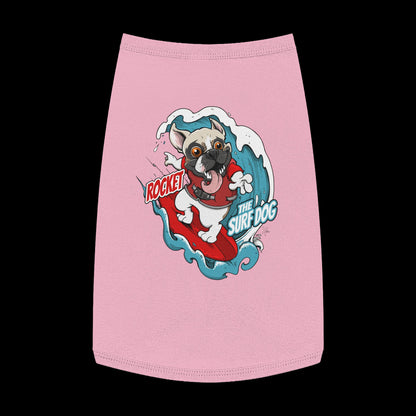 A pink pet shirt featuring a colorful graphic of a French Bulldog surfing on a red board with the text 'ROCKET THE SURF DOG.'