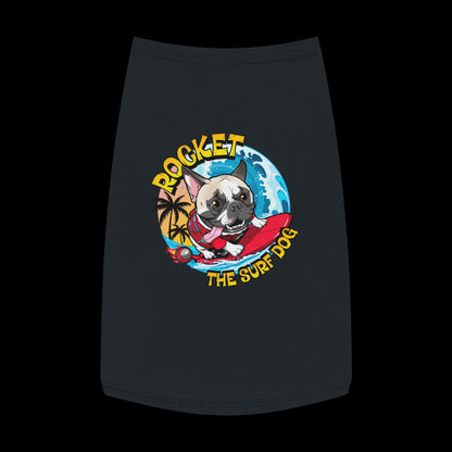 A black pet shirt featuring a colorful graphic of a French Bulldog surfing on a red board with the text 'ROCKET THE SURF DOG' in yellow and blue.