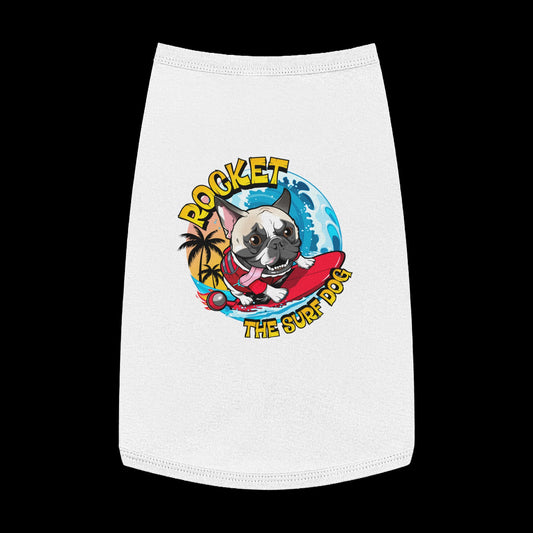 A white pet shirt featuring a colorful graphic of a French Bulldog surfing on a red board with the text 'ROCKET THE SURF DOG' in yellow and blue.