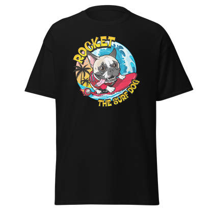 A black short-sleeve crewneck t-shirt featuring a colorful graphic print of a French Bulldog surfing on a red surfboard with the text 'ROCKET THE SURF DOG' in yellow.