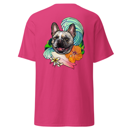 A bright pink short-sleeve t-shirt shown from the back, featuring a large graphic print of a French Bulldog surrounded by a turquoise wave, an orange hibiscus flower, and a pink surfboard.