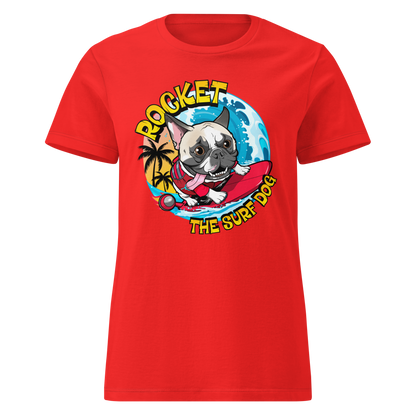 A red short-sleeve crewneck t-shirt featuring a cartoon graphic of a French Bulldog surfing on a red board with the text 'ROCKET THE SURF DOG' in yellow and white.