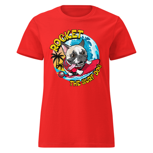 A red short-sleeve crewneck t-shirt featuring a cartoon graphic of a French Bulldog surfing on a red board with the text 'ROCKET THE SURF DOG' in yellow and white.