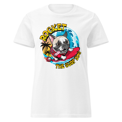 A white short-sleeve crewneck t-shirt featuring a colorful graphic print of a French Bulldog surfing on a red board with the text 'ROCKET THE SURF DOG' and a blue ocean background.